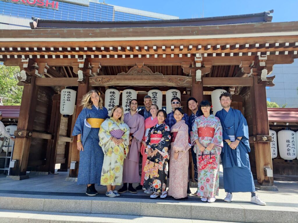 People posing in front of a shrine in traditional dress, Fukuoka, Japan