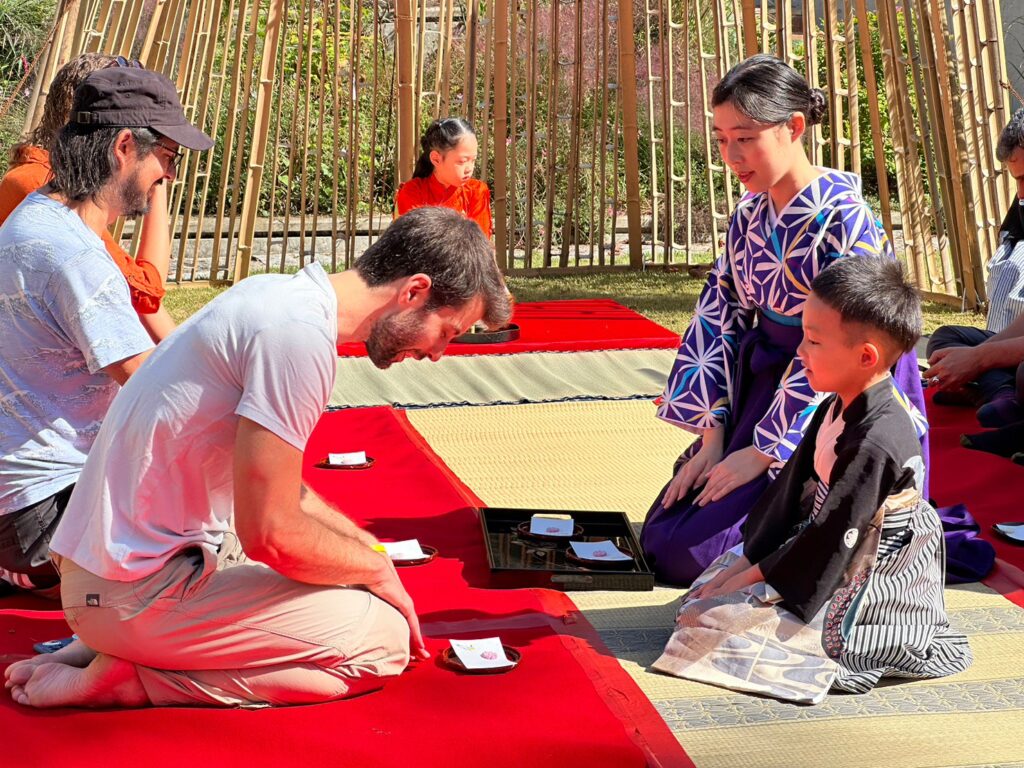 People knealing in traditional dress, Fukuoka, Japan